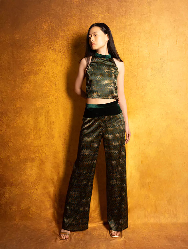 An asian woman wears a silk crop top and high-waisted pants set featuring the VELVET POEM Print, which is inspired by Chinese landscape poetry. She exudes grace in this Modern Chinese chic style.