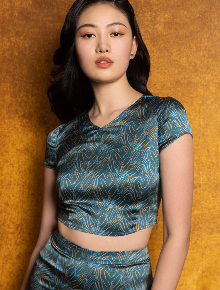 An asian model wears a silk crop top and shorts set featuring the SPRING MOUNTAINS Print. She exudes grace in this Modern Chinese chic style.
