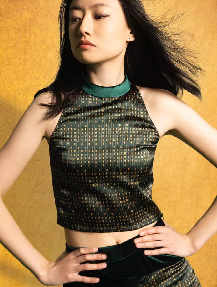 An asian woman wears a silk crop top and high-waisted pants set featuring the VELVET POEM Print, which is inspired by Chinese landscape poetry. She exudes grace in this Modern Chinese chic style. 