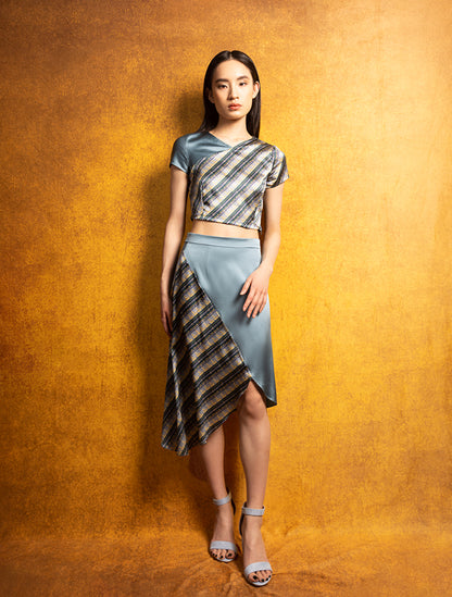 A model wears a silk crop top and high-waisted skirt featuring the BRONZE MOUNTAIN Print. She exudes grace in this Modern Chinese chic style. 