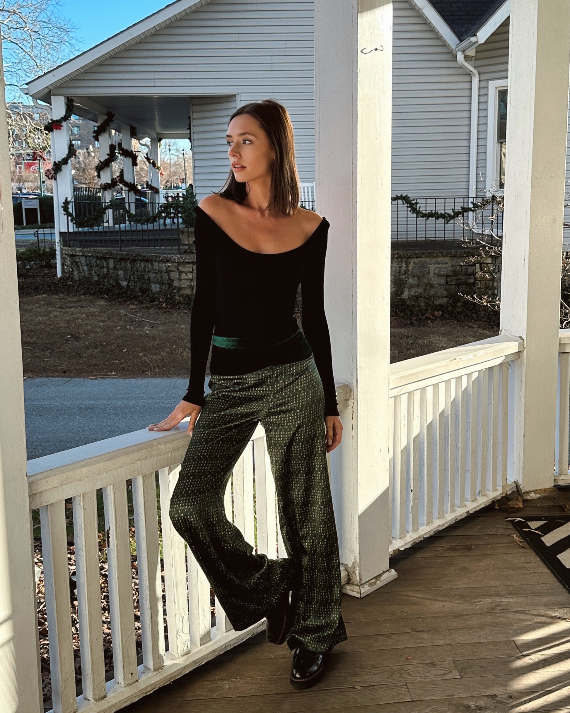 A Caucasian woman wears high-waisted silk pants set featuring the VELVET POEM Print, which is inspired by Chinese landscape poetry. She exudes grace in this Modern Chinese chic style. 
